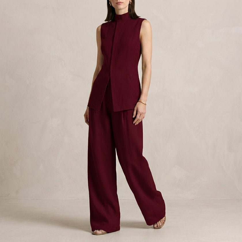 Burgundy women's two-piece co-ord set by FJØRNA with asymmetric high neck top and matching pants, stylish and elegant.