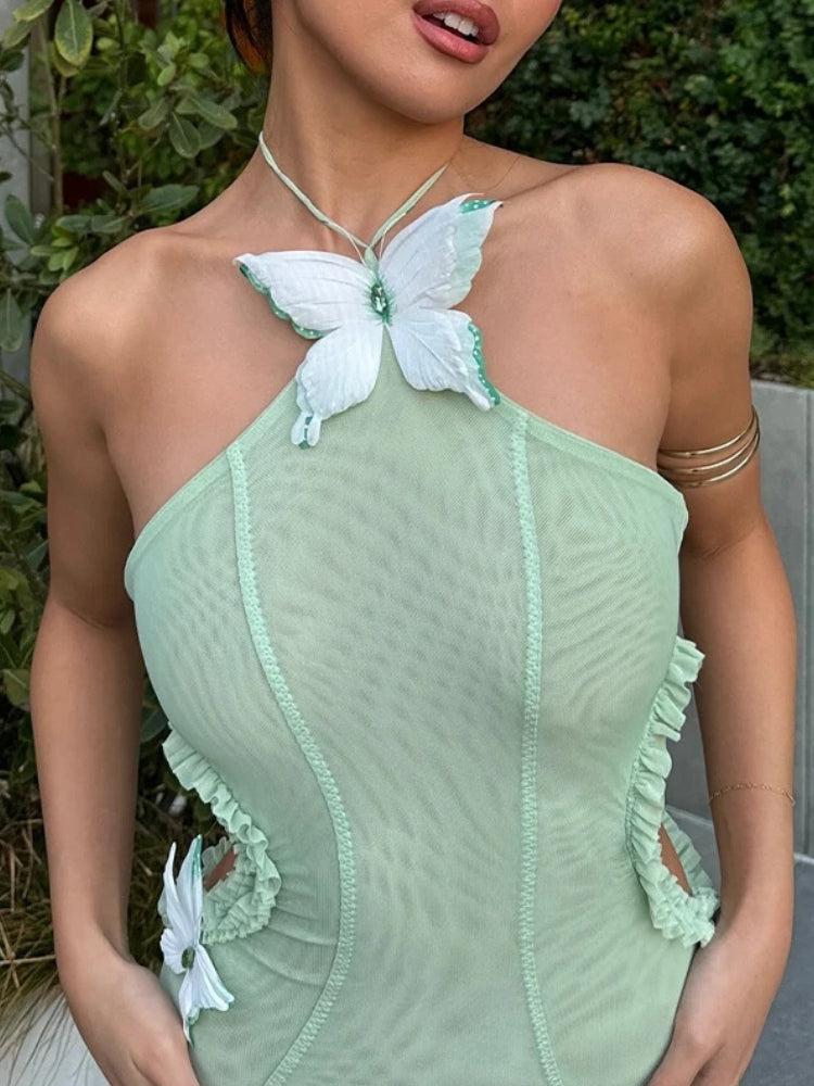 FJØRNA butterfly cut-out women's maxi dress in flowing fabric, perfect for summer and special occasions.