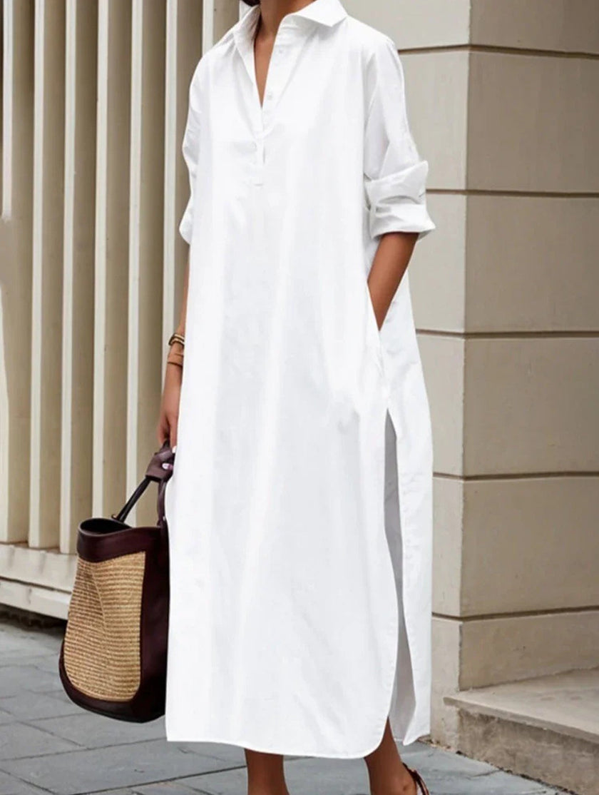 White FJØRNA casual midi dress with lapel button detail and side slit, perfect for casual wear or weddings.