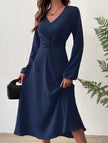 FJØRNA white V-neck lantern long-sleeved dress, stylish and elegant, displayed on a mannequin with a flowing silhouette.