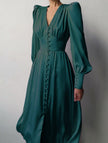 White FJØRNA retro V-neck waist dress displayed on a model, featuring a fitted silhouette and classic design.