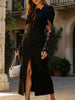 Black openwork dress by FJØRNA featuring lace slit and cinched waist, with flowing fabric and stylish design.