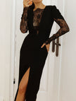 FJØRNA openwork white dress with lace slit and cinched waist, featuring intricate lace details and flowing fabric.