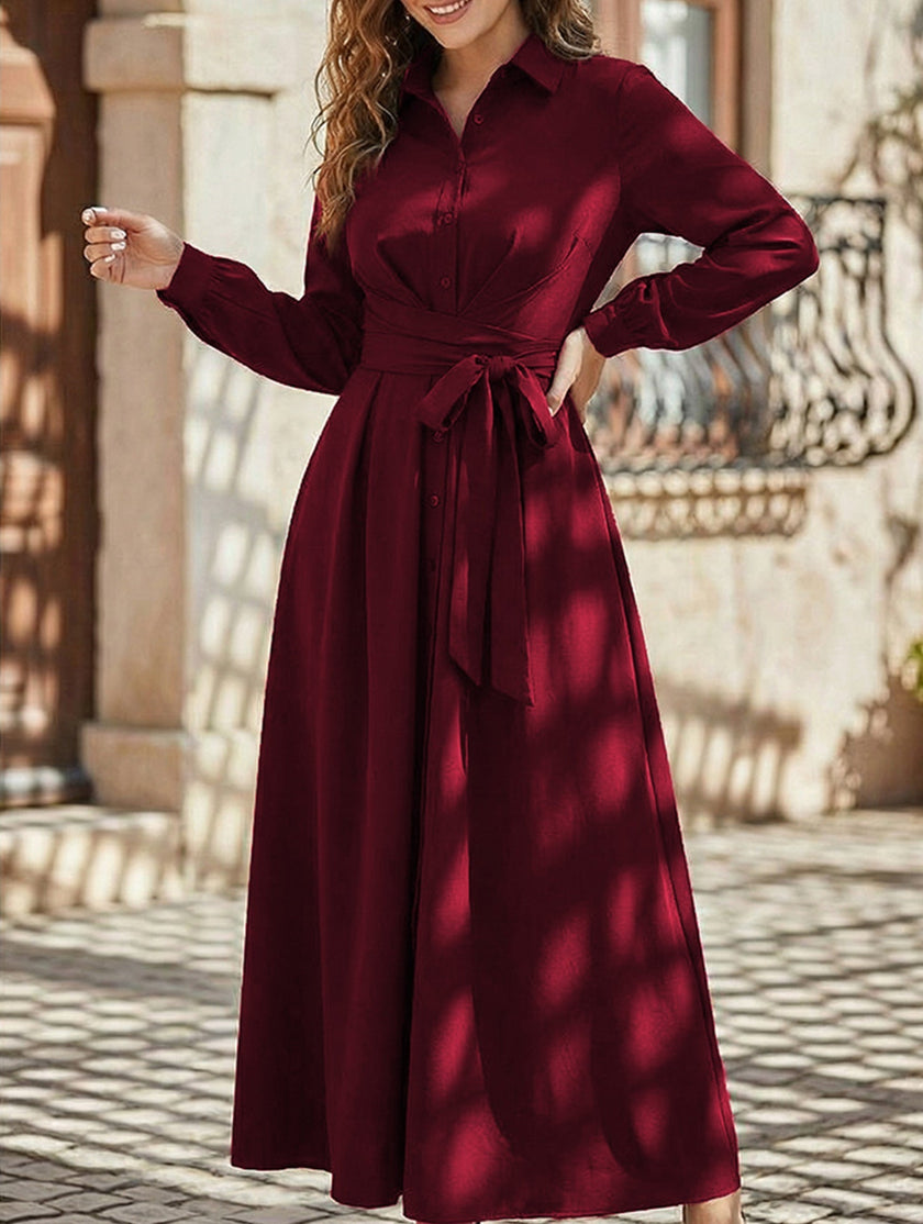 White long-sleeved dress by FJØRNA featuring a simple, elegant design, shown on a model against a neutral background.