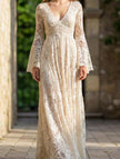 White resort-style lace bell-sleeve long dress by FJØRNA with intricate lace details and flowy bell sleeves.