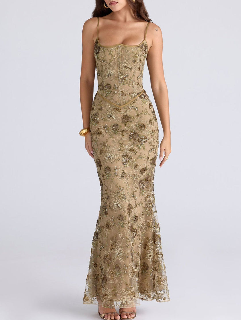 White FJØRNA maxi dress with a low backless design and tie detail, elegant and flowing for formal occasions.