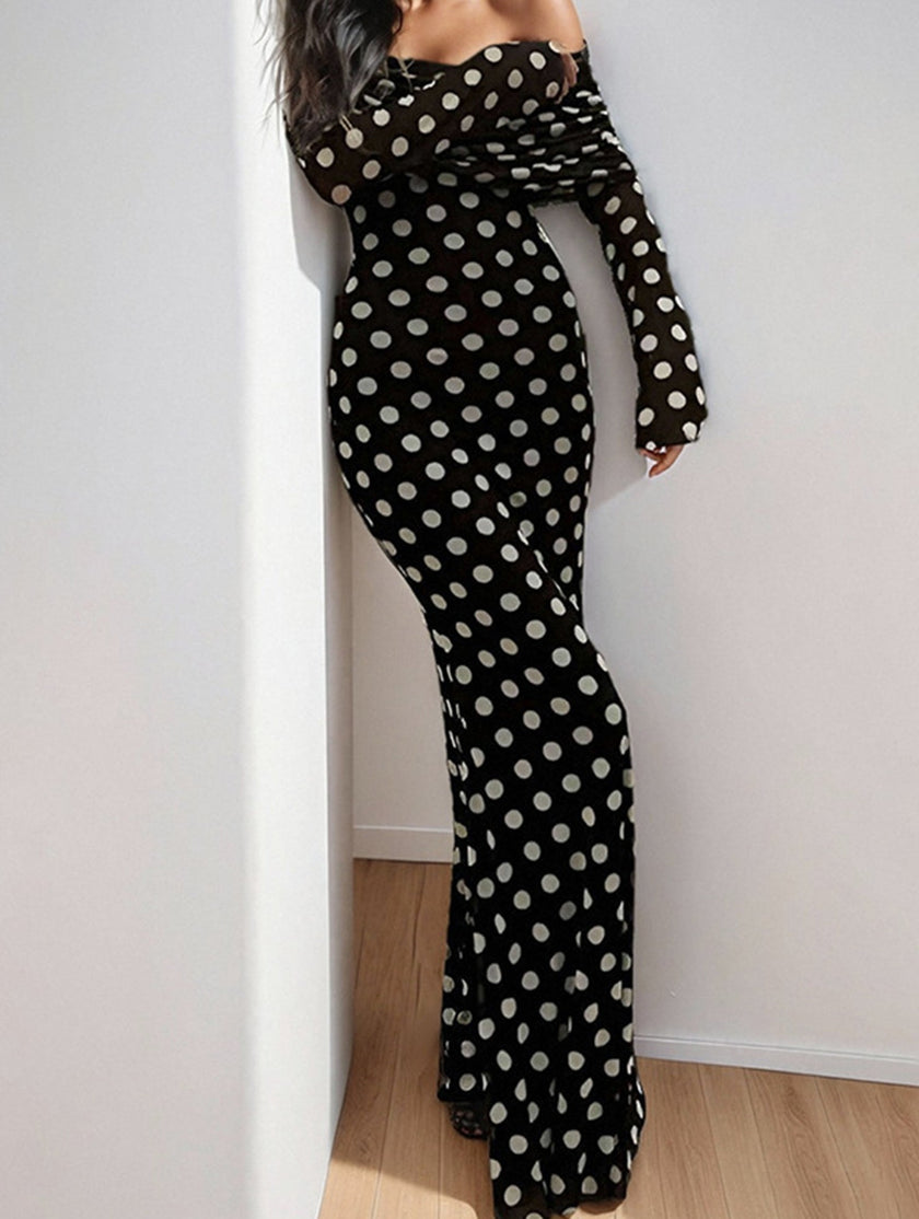 Black polka dot and elegant white dress by FJØRNA, featuring a stylish design and flowing fabric for sophisticated wear.