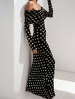 Elegant white dress with black polka dots by FJØRNA, featuring a stylish, flowy design perfect for special occasions.