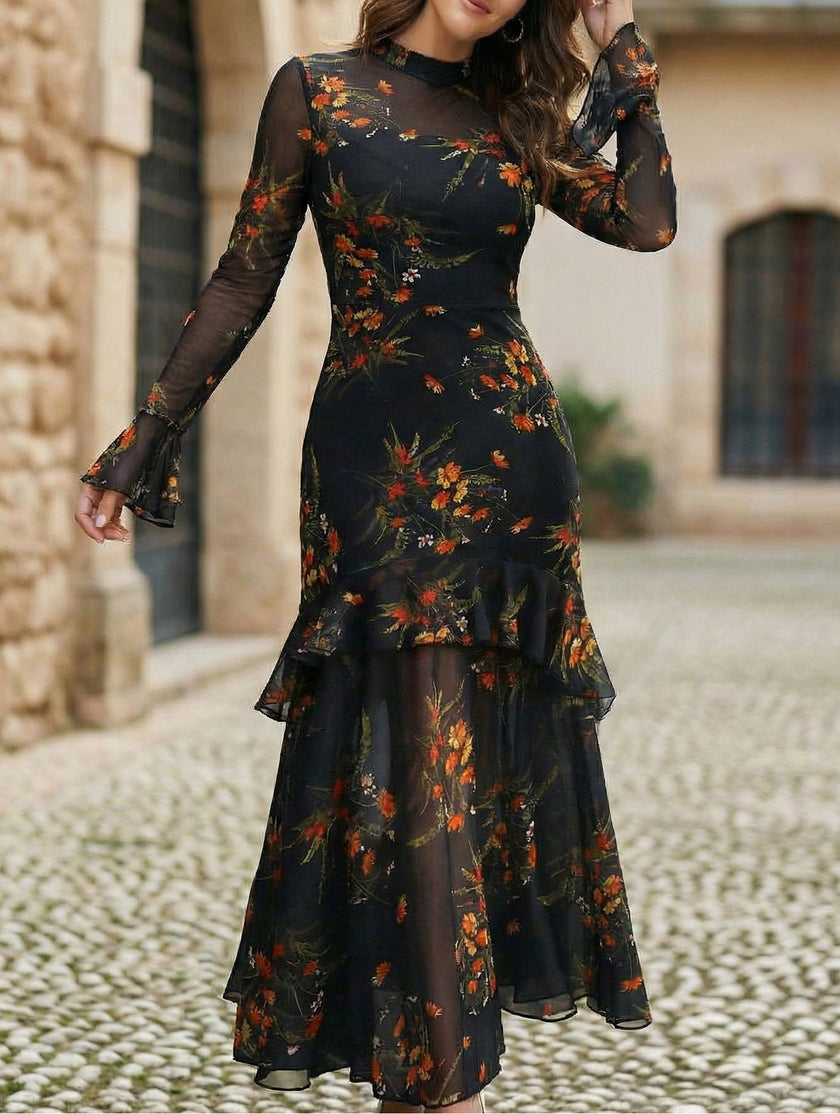 Black women's dress by FJØRNA with lotus leaf sleeves and floral print, featuring a stylish and elegant design.