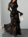 Black women's dress by FJØRNA featuring lotus leaf sleeves and floral print, displayed on a hanger.