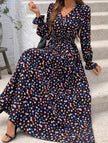 Women's printed V-neck full skirt dress by FJØRNA with a stylish black and white design, perfect for casual or semi-formal occasions.