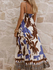 FJØRNA tropical print white maxi dress with cami straps, flowing design and vibrant multicolor floral pattern.