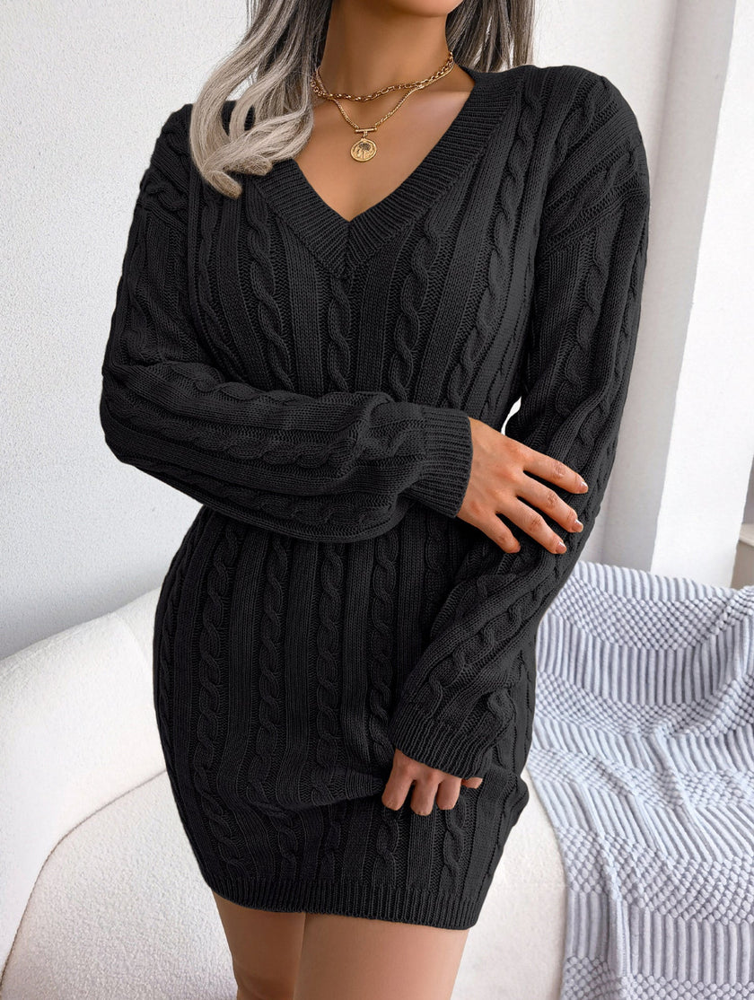 Black cable-knit waist-hugging hip dress by FJØRNA, featuring a stylish and fitted design perfect for fashionable looks.
