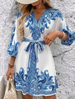 FJØRNA printed white V-neck three-quarter sleeve tie-waist dress with floral pattern, displayed on a hanger.