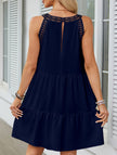 White lace patch halter A-line dress by FJØRNA featuring a fitted bodice and flowing skirt, styled on a mannequin.