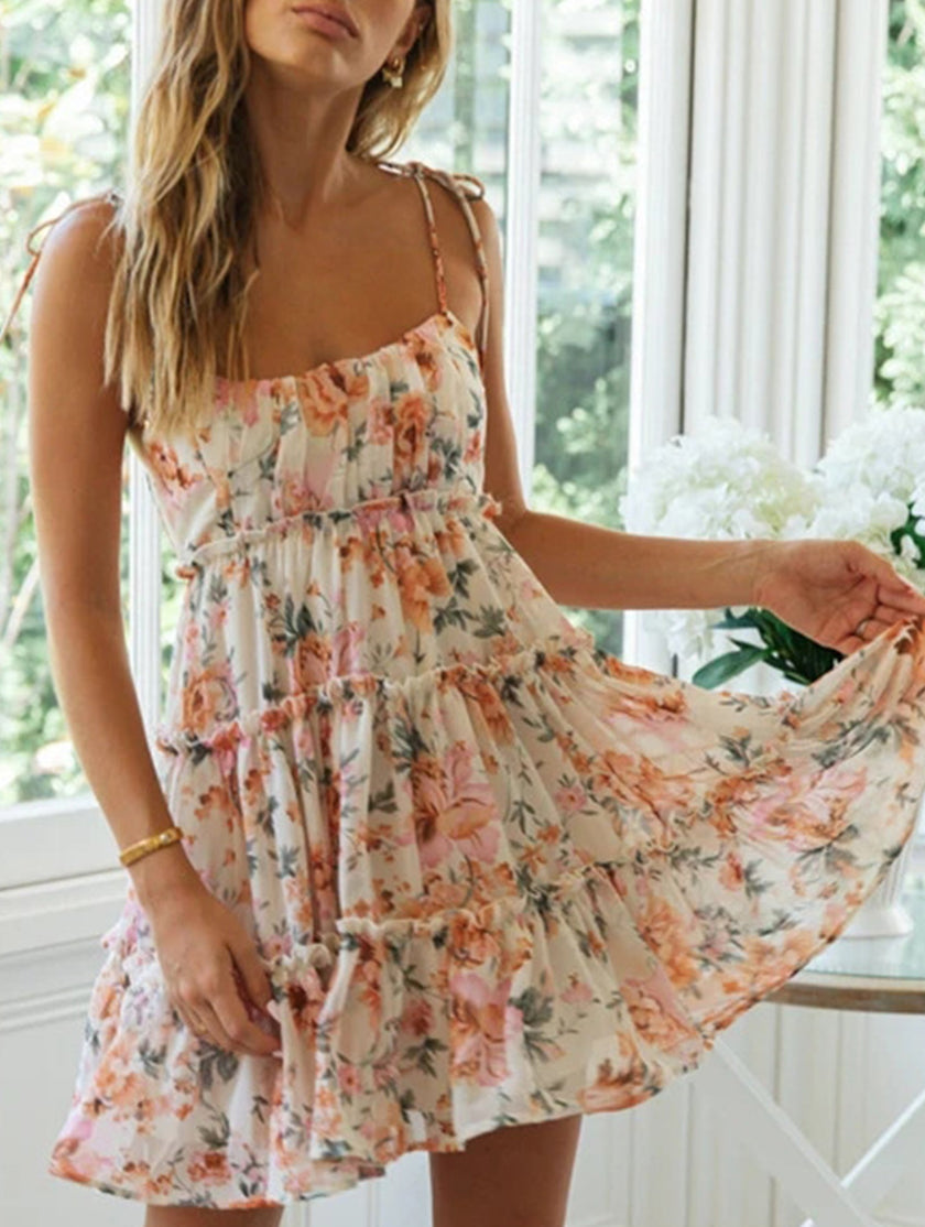 FJØRNA resort style high-end white short dress with vibrant print, perfect for summer and beach occasions.