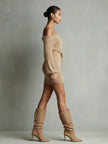 Camel knit off-shoulder mini dress by FJØRNA featuring long sleeves and a fitted silhouette, suitable for evening wear.