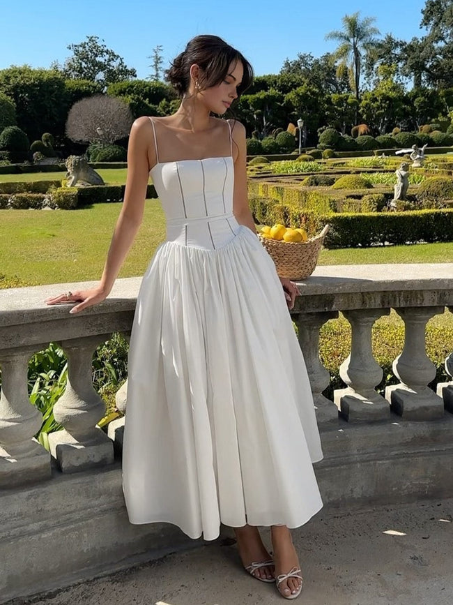 FJØRNA strapless satin corset midi dress with a full skirt, sleeveless and fitted for elegant occasion wear.