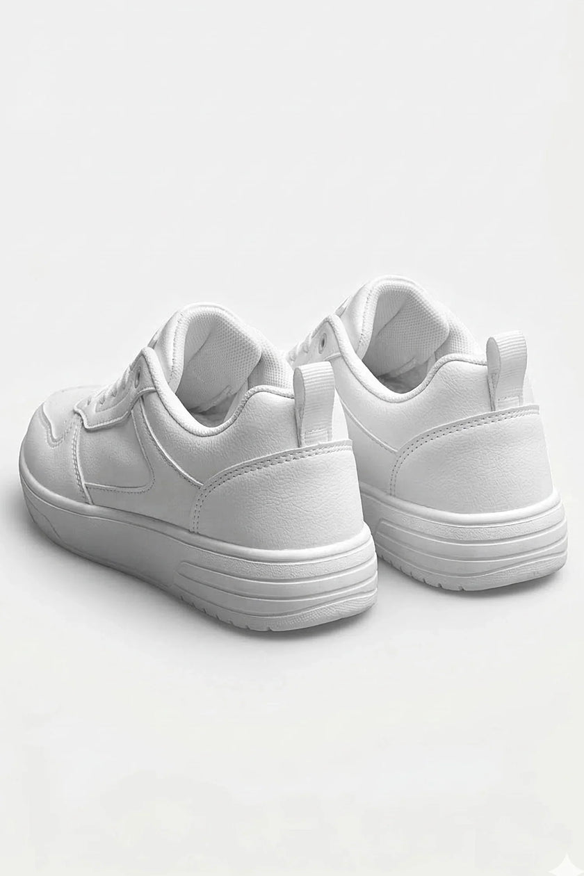 White minimalist women’s casual trainers by FJØRNA, showing sleek, classic white shoes with clean design and comfortable fit.