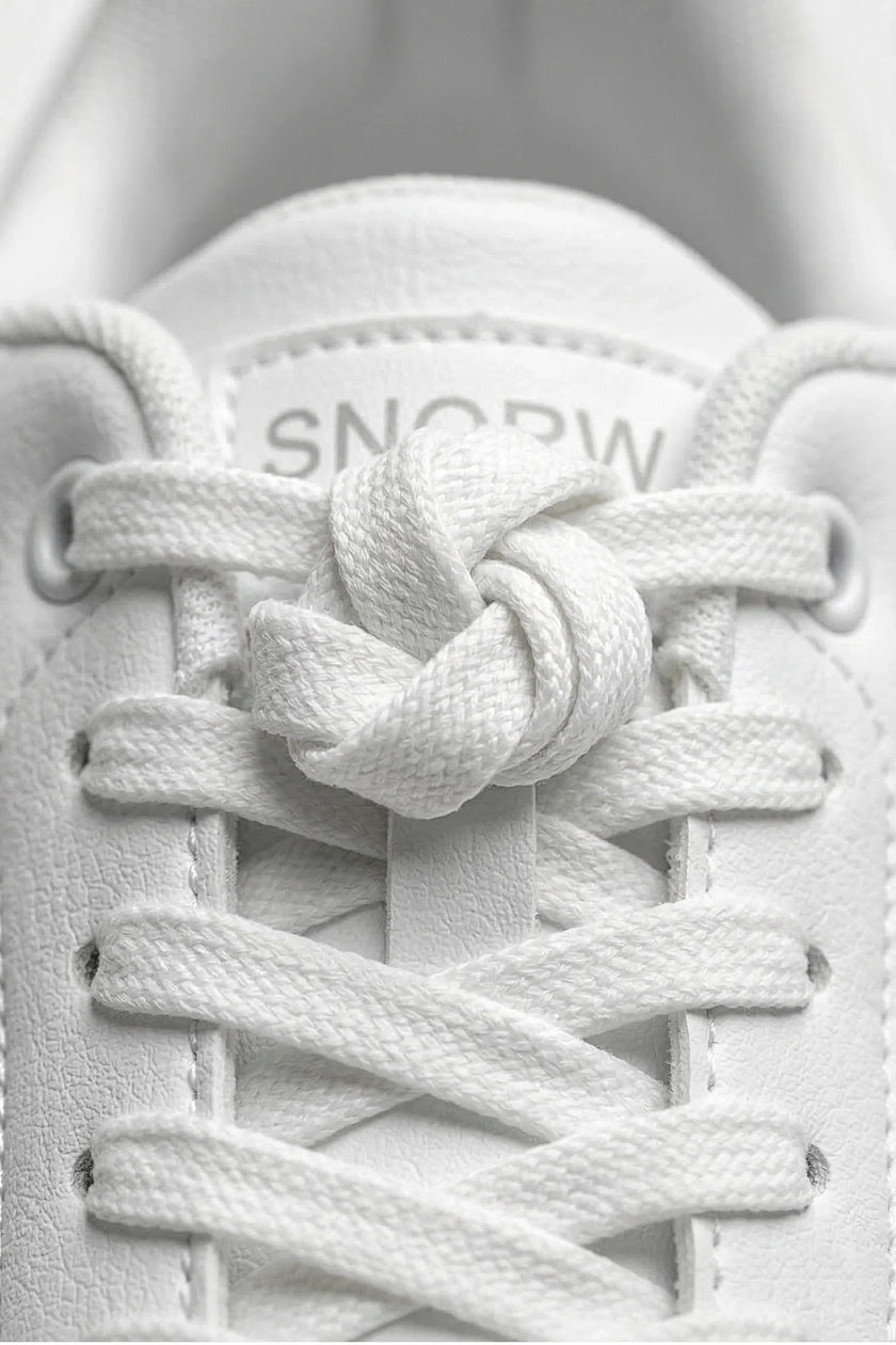 White minimalist FJØRNA women's casual trainers with clean design and classic silhouette, perfect for everyday wear.