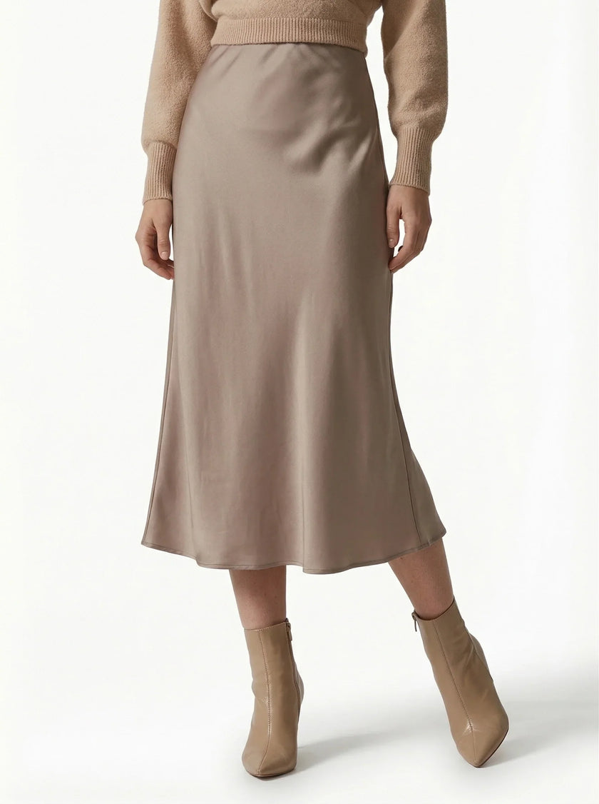 FJØRNA satin high-waist midi pencil skirt for women, flowing and elegant, shown in a flowing satin fabric on a model.