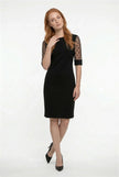 Black A-line lace sleeve midi dress by FJØRNA featuring contrast fabric and elegant design, shown on a model.