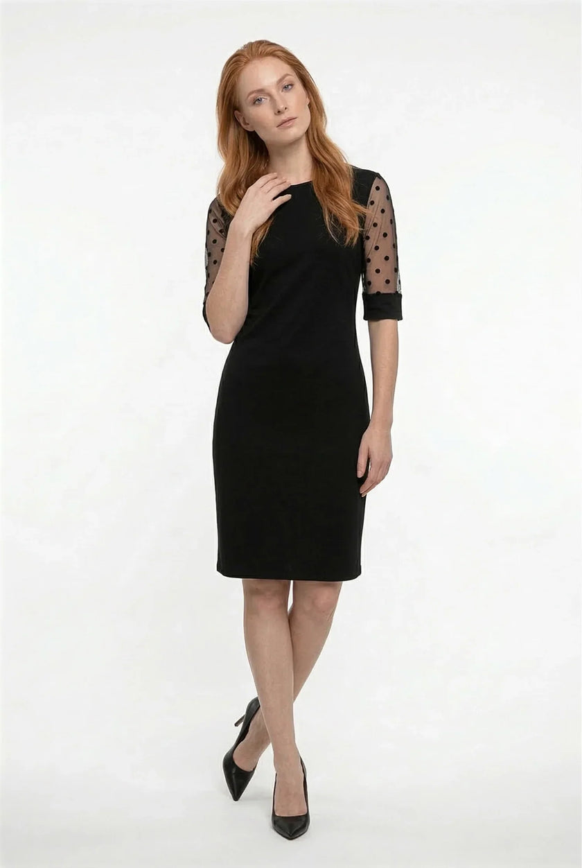Black A-line lace sleeve midi dress by FJØRNA featuring contrast fabric and elegant design, shown on a model.