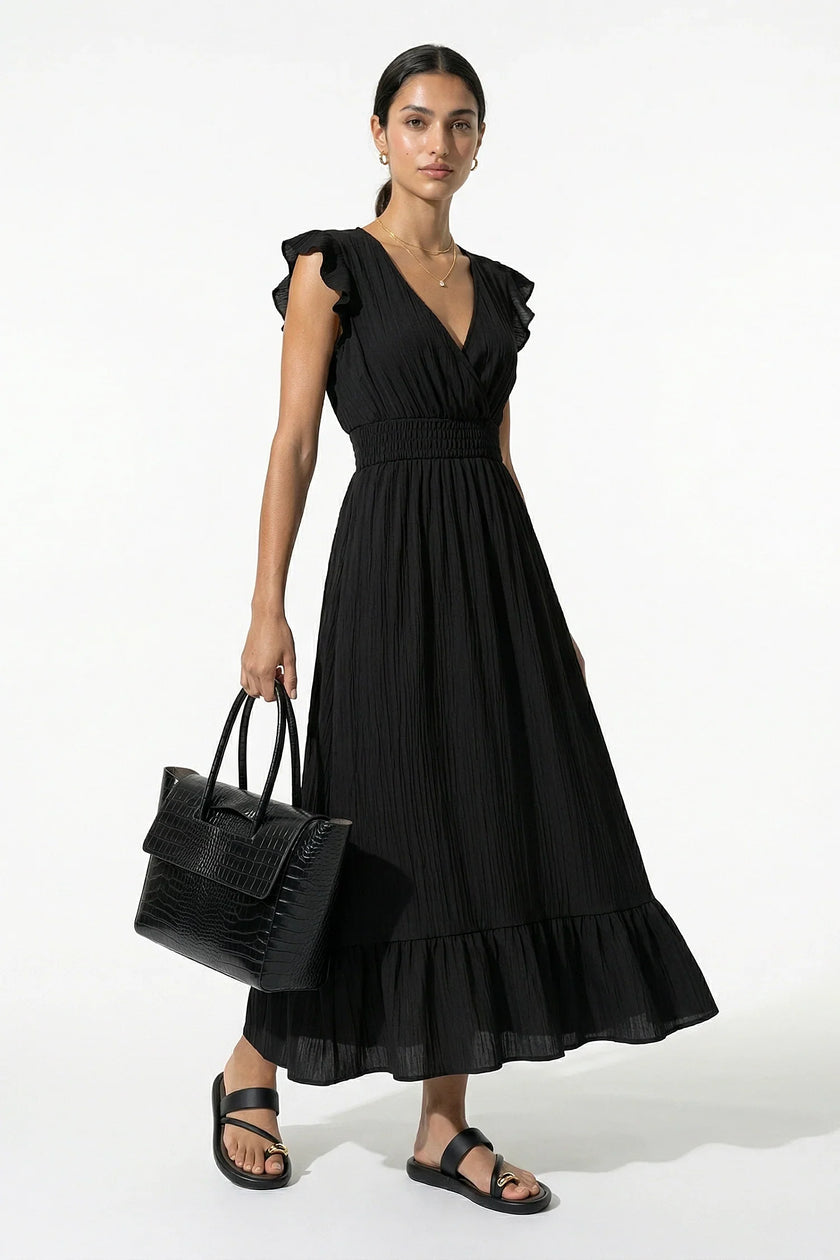 Black FJØRNA flowing sleeveless midi dress for women, elegant and perfect for everyday wear, shown full body in the image.