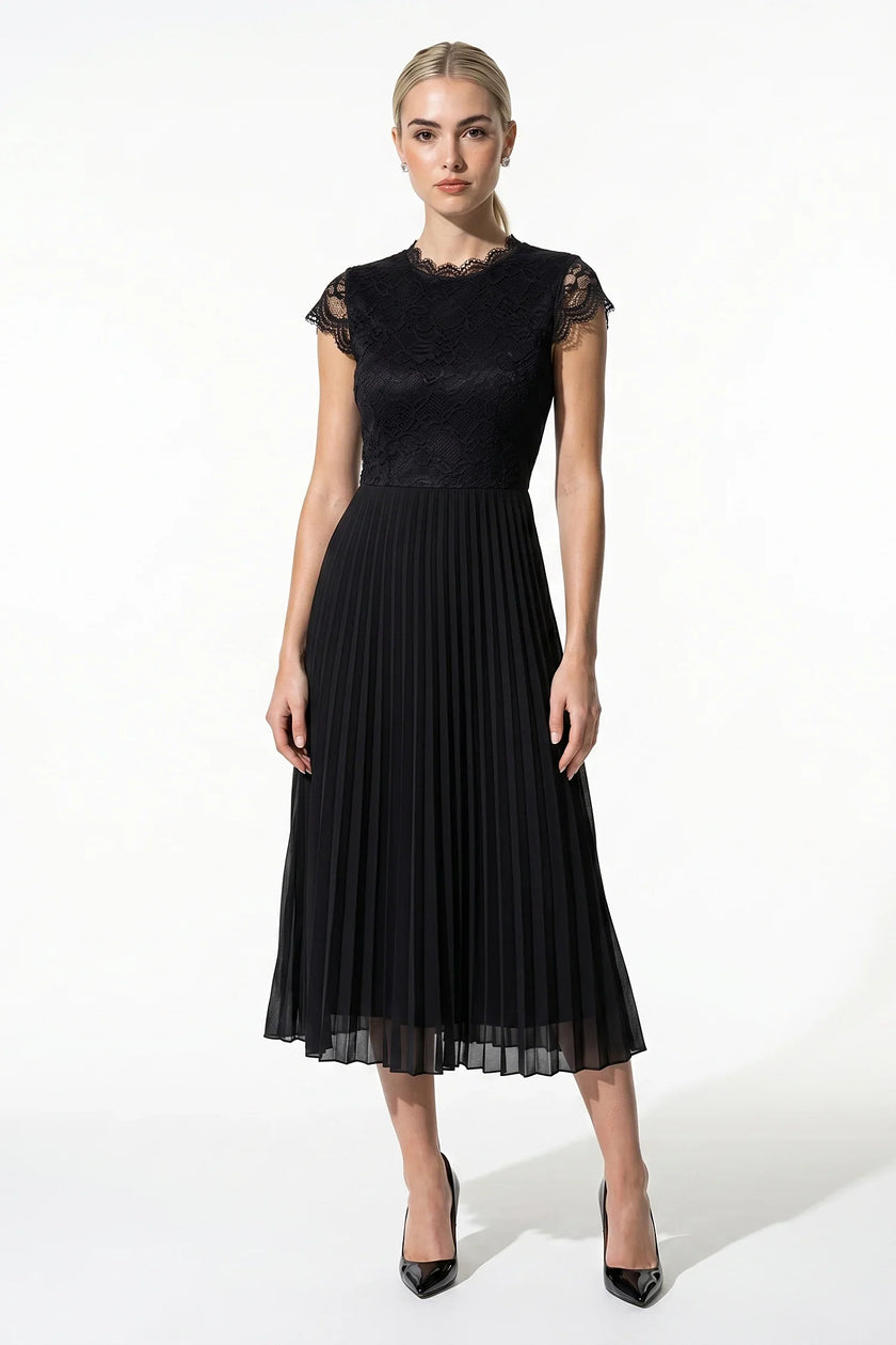 Black floral lace pleated maxi dress by FJØRNA, elegant A-line wedding guest dress with intricate lace details and flowing fabric.