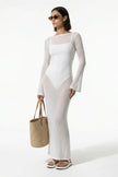 White women's long-sleeve flowing maxi dress by FJØRNA, perfect for summer beachwear, full-body view.