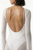 White women's long-sleeve flowing maxi dress by FJØRNA, perfect for summer beach occasions, shown in a close-up view.
