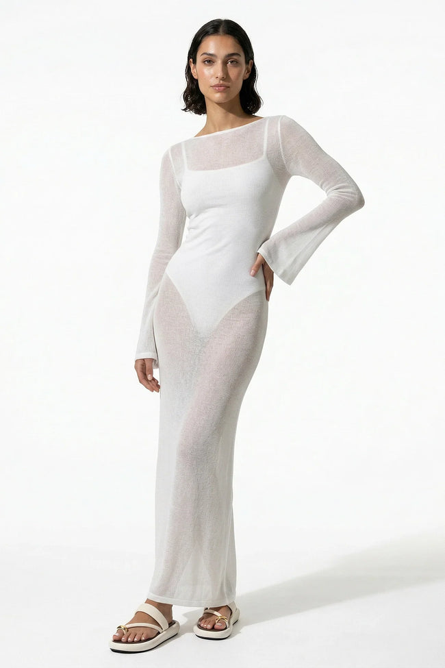 White women's long-sleeve flowing maxi dress by FJØRNA, perfect for summer beachwear, shown on a model.
