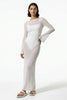 White women's long-sleeve flowing maxi dress by FJØRNA, perfect for summer beachwear, shown on a model.