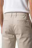 Men's FJØRNA cotton tailored chino shorts in white, featuring a close-up view of the premium fabric and tailored fit.