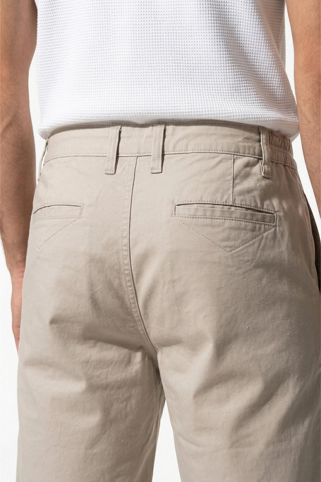 Men's FJØRNA cotton tailored chino shorts in white, featuring a close-up view of the premium fabric and tailored fit.