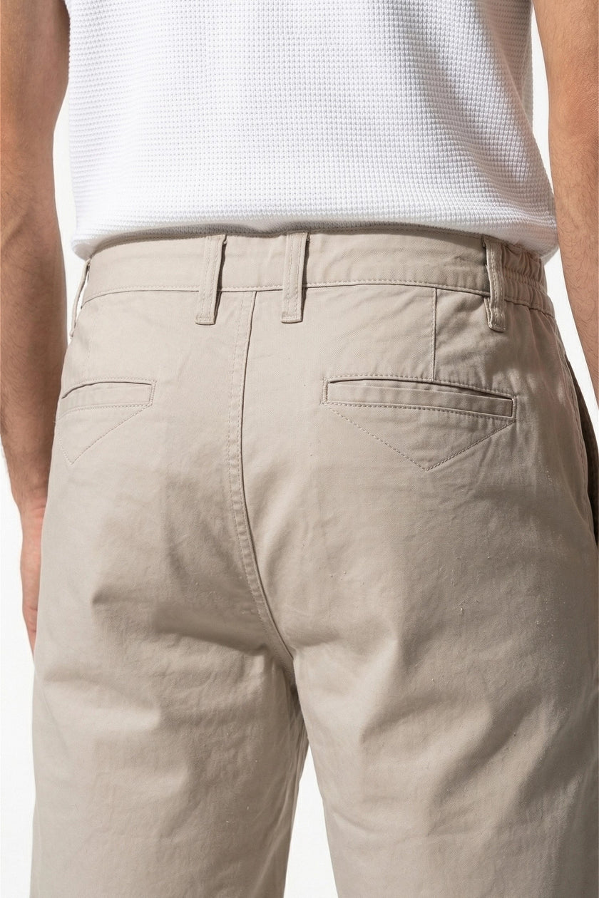 Men's FJØRNA cotton tailored chino shorts in white, featuring a close-up view of the premium fabric and tailored fit.