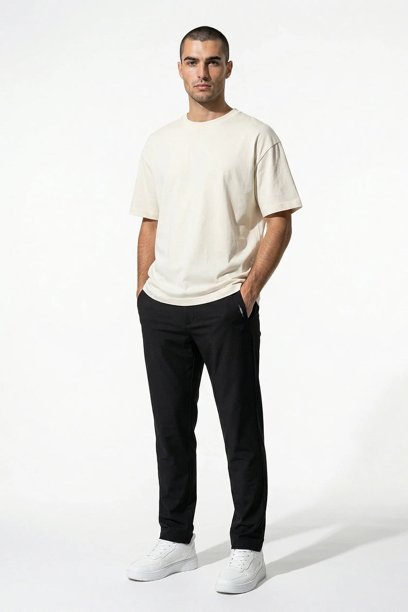 Men's slim fit stretch chino trousers by FJØRNA in black, full-body view showcasing tailored slim fit design and stretch fabric.