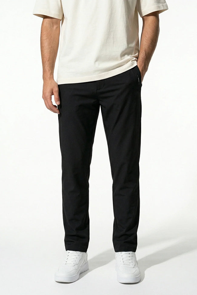 Men's slim fit stretch chino trousers in black by FJØRNA, showcasing sleek, tailored design and comfortable fit for stylish casual wear.