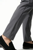 Men's slim fit stretch chino trousers in dark grey by FJØRNA, showcasing sleek, tailored design and fine fabric texture.
