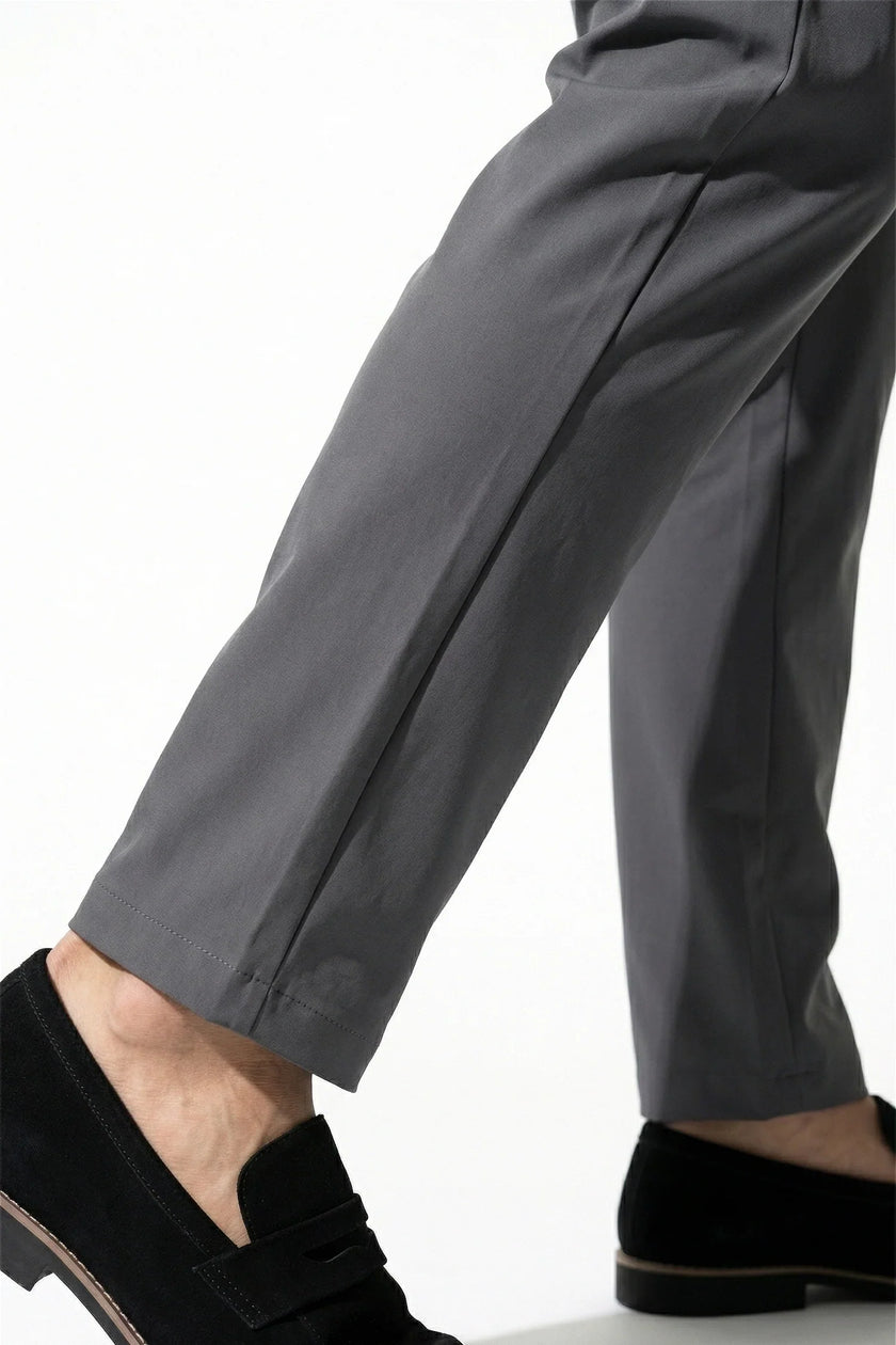 Men's slim fit stretch chino trousers in dark grey by FJØRNA, showcasing sleek, tailored design and fine fabric texture.