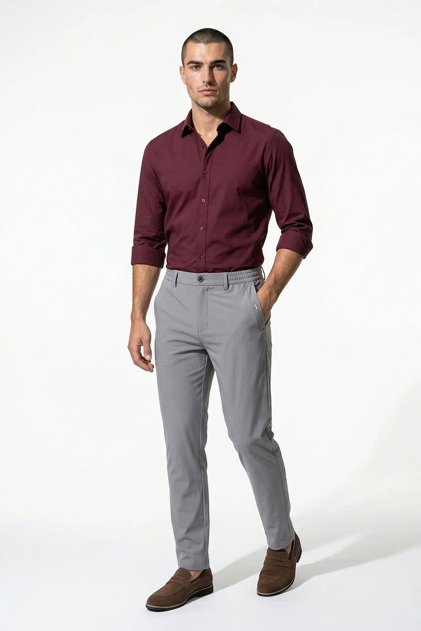 Men's slim fit stretch chino trousers in light grey by FJØRNA, shown as full-body view, highlighting tailored slim fit design.