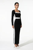 Black and white monochrome bodycon maxi dress for women by FJØRNA, shown from a 3/4 view highlighting fitted silhouette and stylish design.