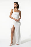 FJØRNA black sleeveless maxi dress with high slit, flowing design, and elegant style for women, shown full body in the image.