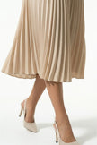FJØRNA apricot pleated midi dress for women with A-line silhouette and round neckline, casual style, close-up view.