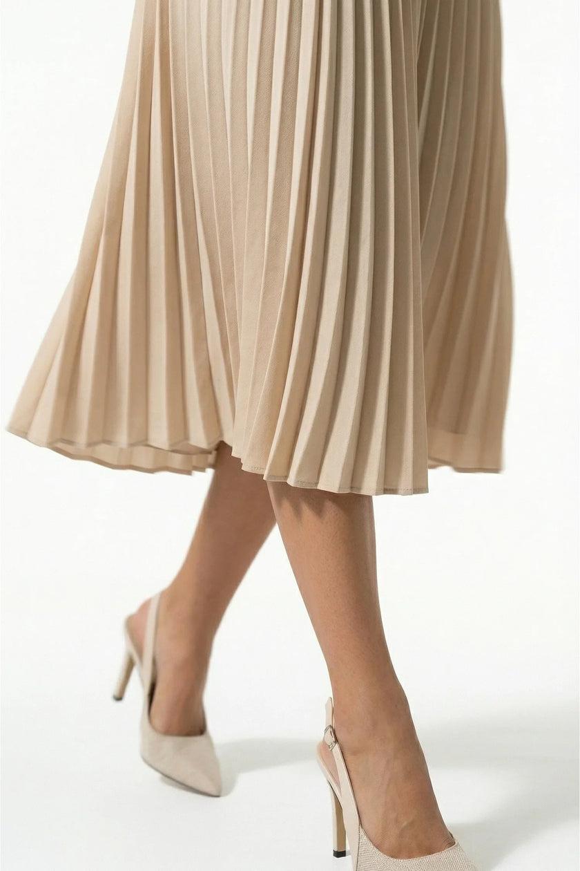 FJØRNA apricot pleated midi dress for women with A-line silhouette and round neckline, casual style, close-up view.