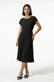 Black FJØRNA pleated midi dress for women, A-line silhouette with round neck, casual style, full-body view.