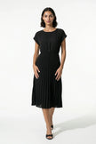 Black FJØRNA women's pleated midi dress with A-line silhouette and round neck, casual style perfect for everyday wear.
