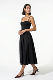 FJØRNA black sleeveless pleated backless midi dress with halter neck, perfect for occasions, shown on a full body model.