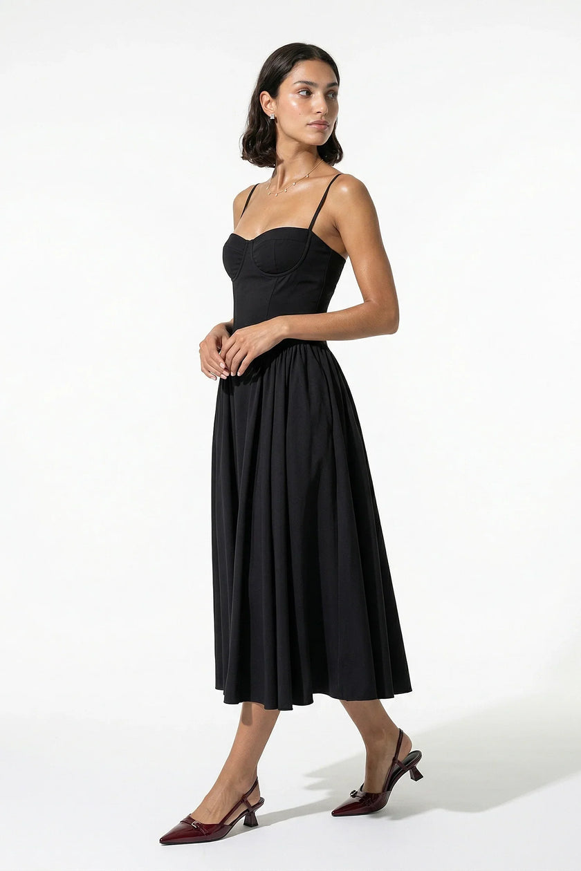 FJØRNA black sleeveless pleated backless midi dress with halter neck, perfect for occasions, shown on a full body model.