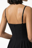 Black FJØRNA sleeveless pleated halter backless midi dress, elegant occasion dress shown in close-up.